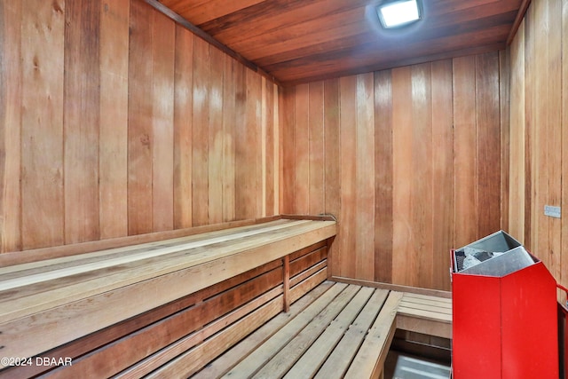 view of sauna / steam room featuring wooden walls and wooden ceiling