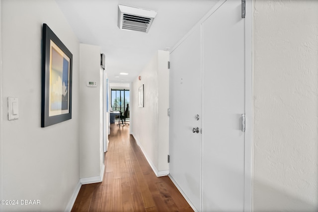 corridor featuring dark wood-type flooring