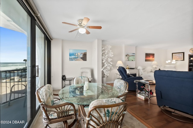 dining room featuring hardwood / wood-style floors, ceiling fan, and a water view