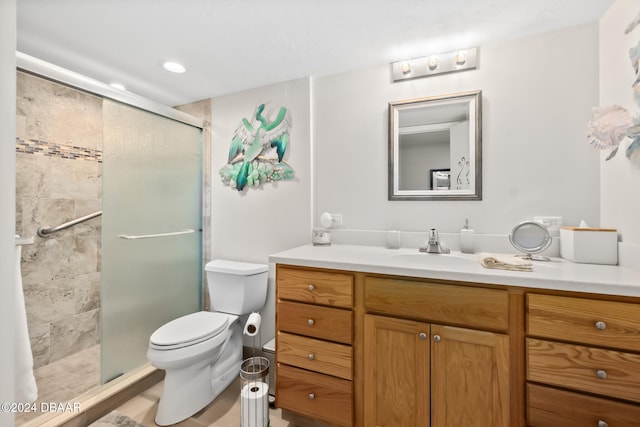 bathroom with vanity, toilet, and an enclosed shower