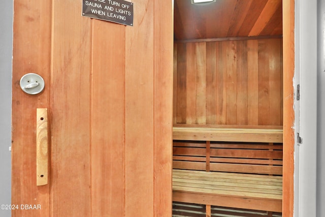 view of sauna / steam room featuring wood walls and wooden ceiling