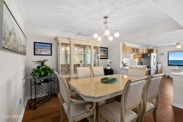 dining space with ornamental molding, ceiling fan with notable chandelier, and dark hardwood / wood-style floors