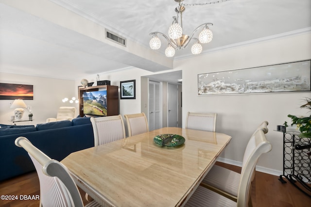 dining area with ornamental molding, dark hardwood / wood-style flooring, and a chandelier