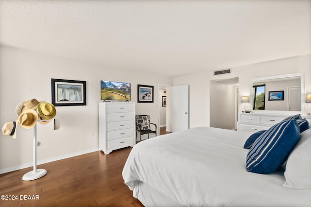 bedroom featuring dark hardwood / wood-style flooring