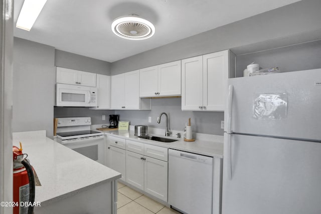 kitchen featuring white cabinets, sink, white appliances, and light tile patterned floors