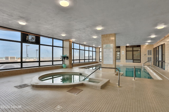 view of pool with an indoor hot tub