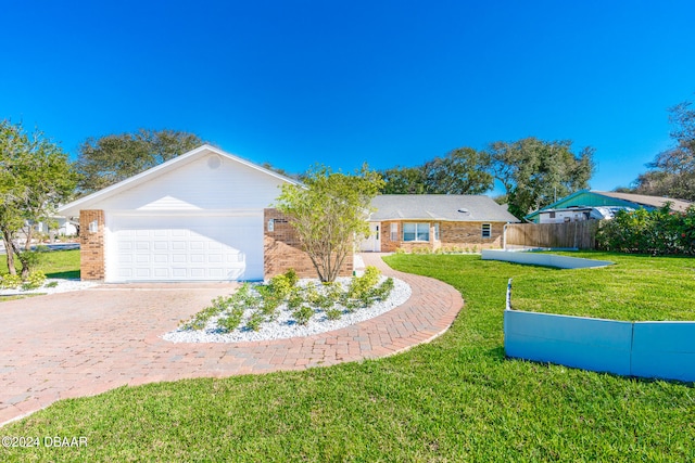 ranch-style home with a garage and a front lawn