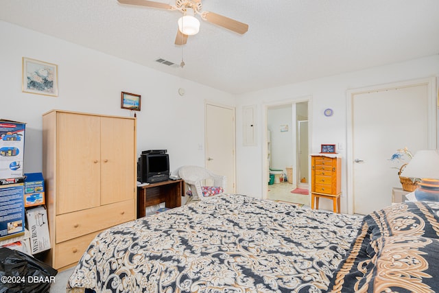 bedroom featuring a textured ceiling, ensuite bath, ceiling fan, and a closet