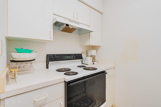 kitchen with white cabinetry and electric range