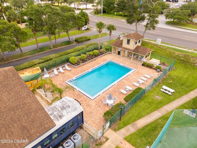 view of pool with an outbuilding, a patio, and cooling unit