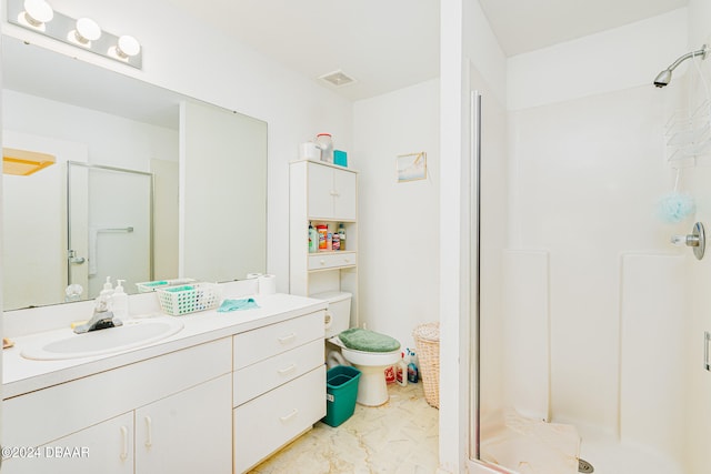 bathroom featuring vanity, toilet, and an enclosed shower