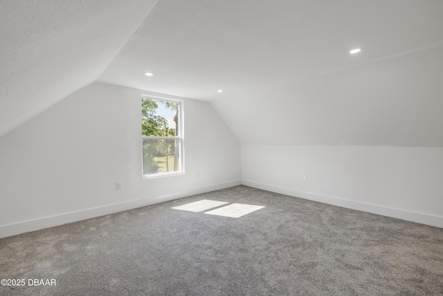 182 Howes St, Oak Hill, FL 32759 - bonus room with baseboards, lofted ceiling, and carpet floors