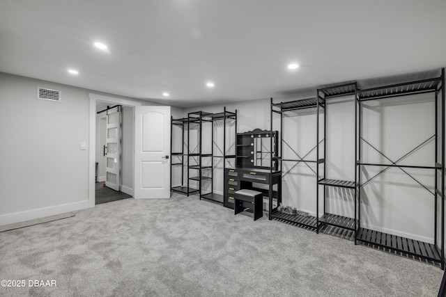 182 Howes St, Oak Hill, FL 32759 - finished below grade area with carpet, a barn door, baseboards, visible vents, and recessed lighting