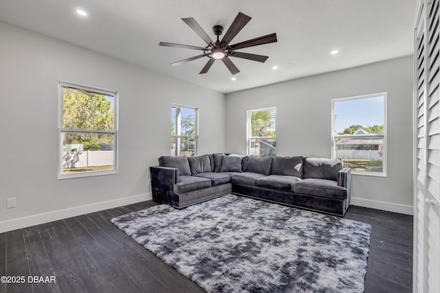 182 Howes St, Oak Hill, FL 32759 - living room featuring baseboards, dark wood-style floors, ceiling fan, and a wealth of natural light