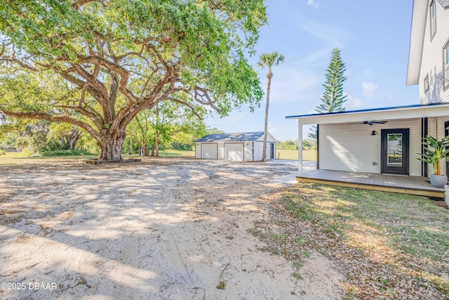 182 Howes St, Oak Hill, FL 32759 - view of yard with driveway, a detached garage, and an outbuilding
