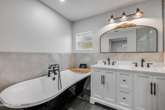 182 Howes St, Oak Hill, FL 32759 - bathroom with tile walls, double vanity, a sink, and a soaking tub