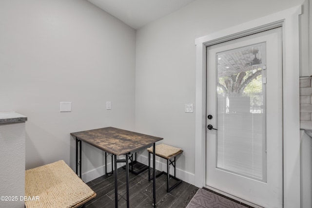 182 Howes St, Oak Hill, FL 32759 - doorway to outside featuring baseboards and dark wood-style floors