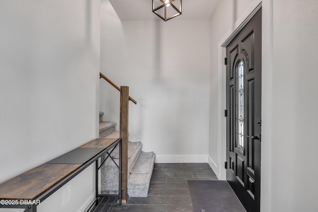 182 Howes St, Oak Hill, FL 32759 - entrance foyer with baseboards, wood tiled floor, and stairway