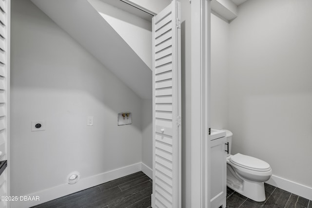182 Howes St, Oak Hill, FL 32759 - bathroom with baseboards, wood finished floors, and toilet