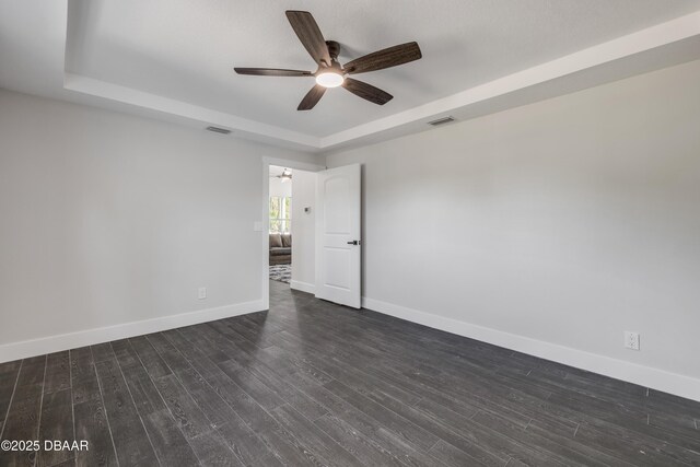 182 Howes St, Oak Hill, FL 32759 - unfurnished room with a ceiling fan, a raised ceiling, dark wood-style flooring, and visible vents
