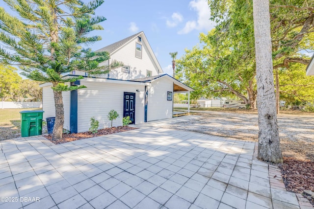 182 Howes St, Oak Hill, FL 32759 - view of side of home with driveway and fence