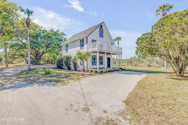 182 Howes St, Oak Hill, FL 32759 - view of front of house with a front yard and dirt driveway