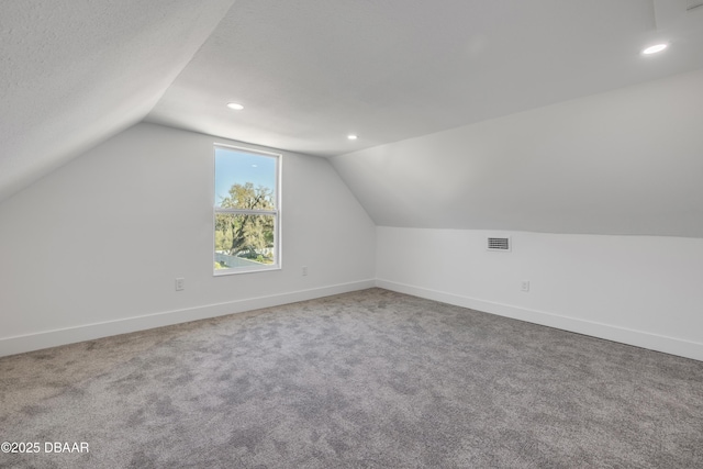 182 Howes St, Oak Hill, FL 32759 - bonus room featuring vaulted ceiling, recessed lighting, carpet, baseboards, and visible vents