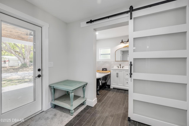 182 Howes St, Oak Hill, FL 32759 - interior space featuring wood tiled floor, a barn door, and a sink