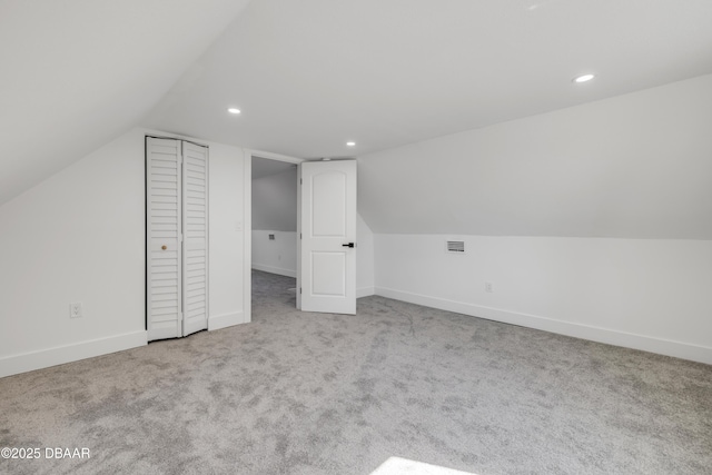 182 Howes St, Oak Hill, FL 32759 - bonus room with baseboards, vaulted ceiling, visible vents, and carpet floors