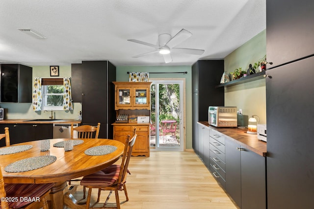 292 Fir St, Ormond Beach, FL 32174 - dining space featuring a ceiling fan, light wood-style flooring, and a textured ceiling