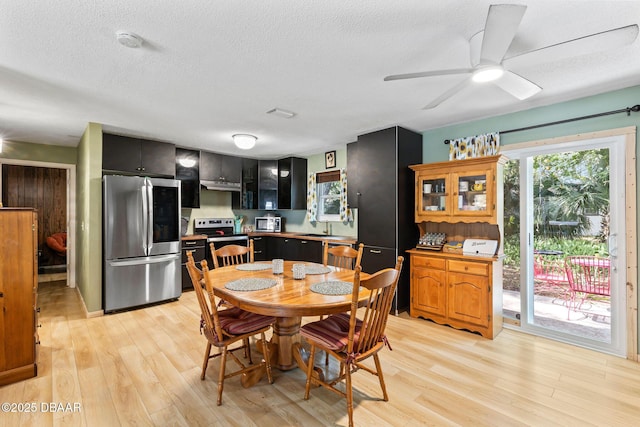 292 Fir St, Ormond Beach, FL 32174 - dining room with light wood-style flooring, a textured ceiling, and ceiling fan