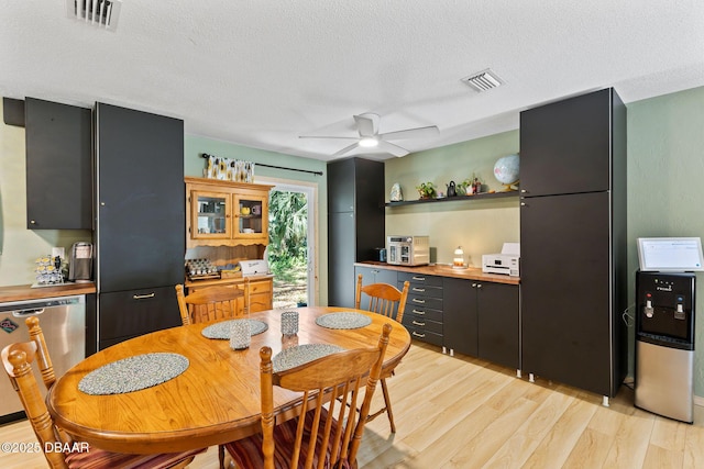 292 Fir St, Ormond Beach, FL 32174 - dining area featuring light wood-type flooring, a ceiling fan, and a textured ceiling