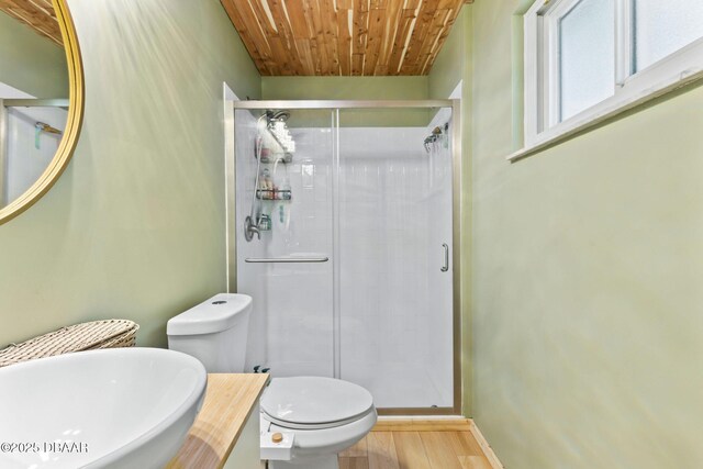 292 Fir St, Ormond Beach, FL 32174 - bathroom featuring wood ceiling, wood finished floors, toilet, a stall shower, and baseboards