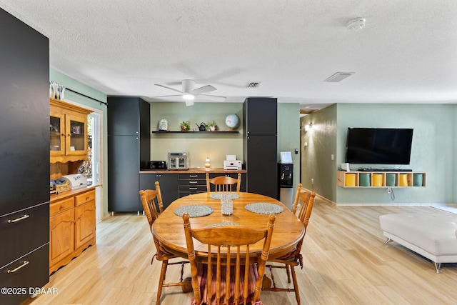 292 Fir St, Ormond Beach, FL 32174 - dining area featuring light wood finished floors, a ceiling fan, and a textured ceiling