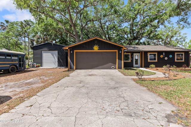 292 Fir St, Ormond Beach, FL 32174 - view of front of house featuring a garage, concrete driveway, and board and batten siding