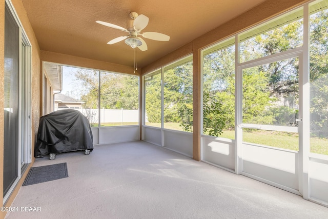 unfurnished sunroom with ceiling fan and a healthy amount of sunlight