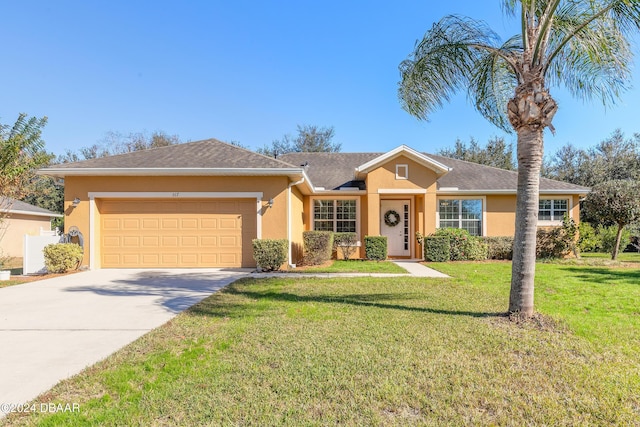 ranch-style home featuring a garage and a front lawn