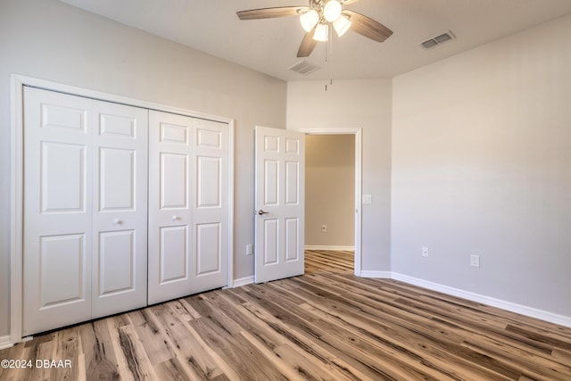 unfurnished bedroom with ceiling fan, a closet, and light hardwood / wood-style flooring