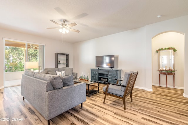 living room with ceiling fan and light hardwood / wood-style flooring