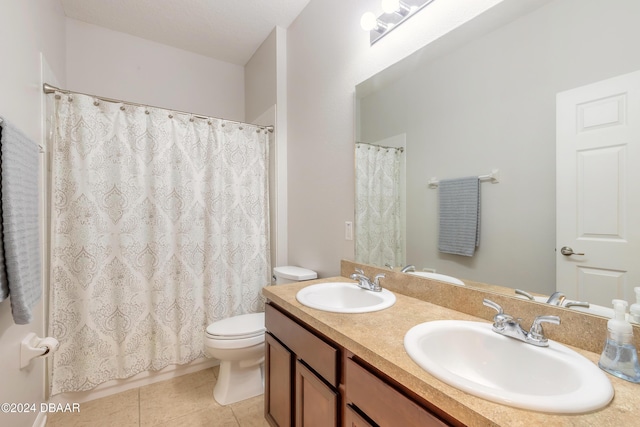 bathroom with tile patterned flooring, vanity, and toilet