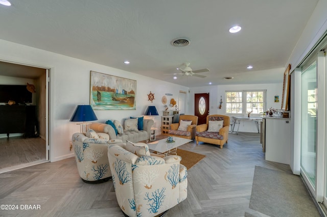 living room featuring light parquet flooring and ceiling fan