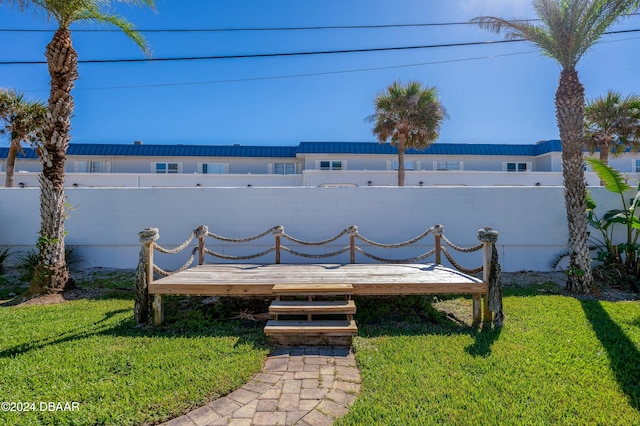 wooden deck featuring a lawn