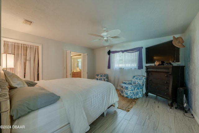 bedroom featuring ensuite bathroom, ceiling fan, and light hardwood / wood-style floors