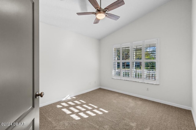 carpeted empty room featuring lofted ceiling, baseboards, and ceiling fan