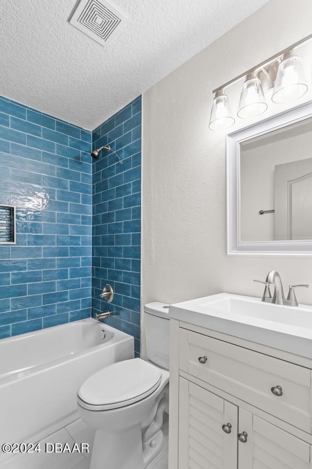 bathroom featuring vanity, washtub / shower combination, visible vents, a textured ceiling, and toilet