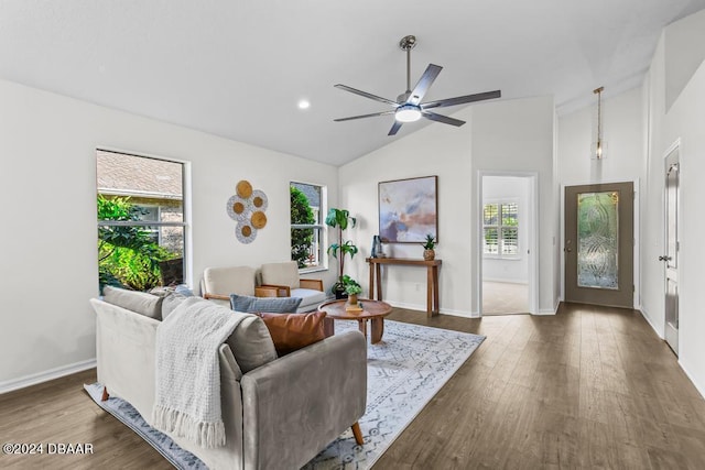 living room with vaulted ceiling, wood finished floors, baseboards, and ceiling fan