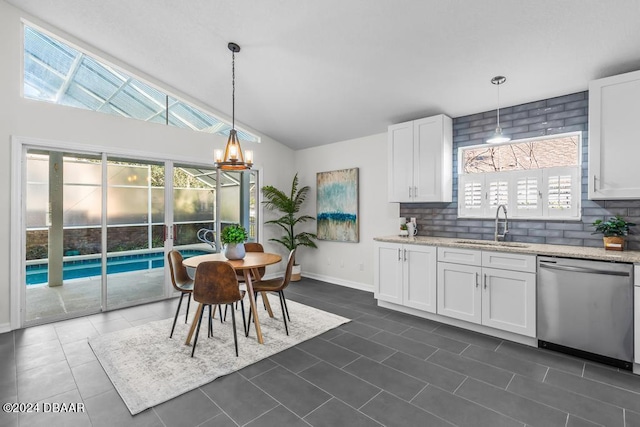 kitchen featuring stainless steel dishwasher, light stone counters, white cabinetry, and a sink