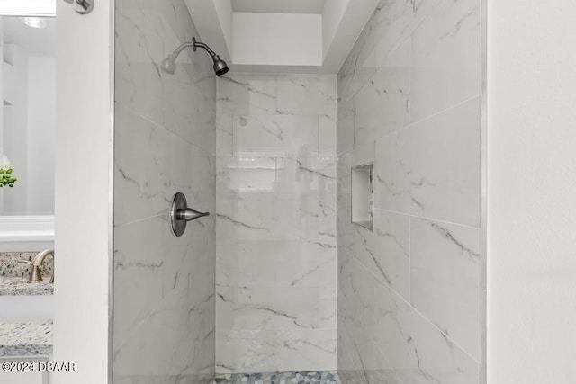 bathroom featuring a marble finish shower