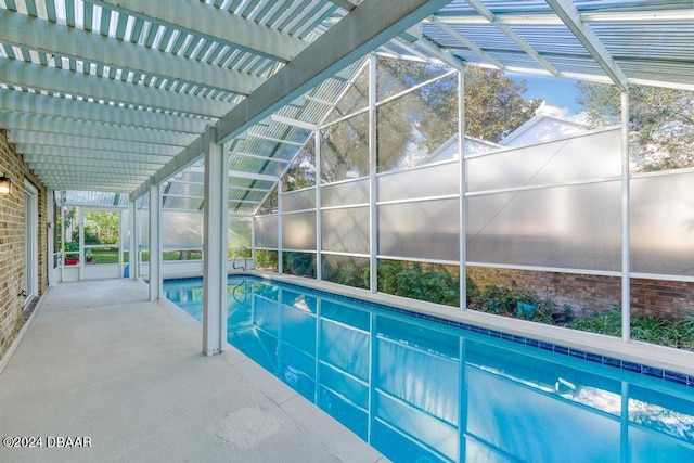 indoor pool with glass enclosure and a patio area