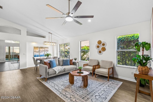 living room featuring lofted ceiling, wood finished floors, and a healthy amount of sunlight